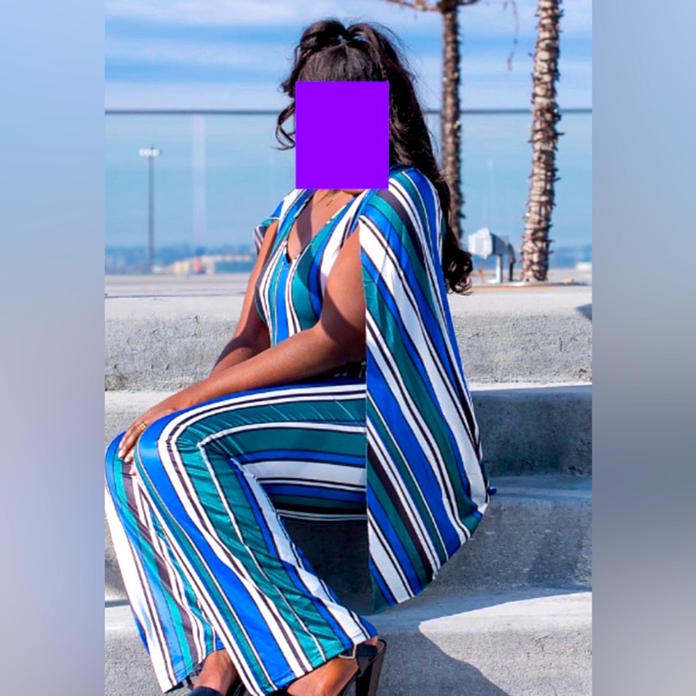 Stripped one piece jumpsuit with attached matching cape.